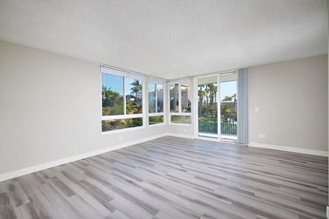 A room with a sliding glass door leading to a balcony.