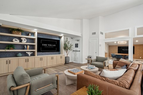 a living room with couches and chairs and a television