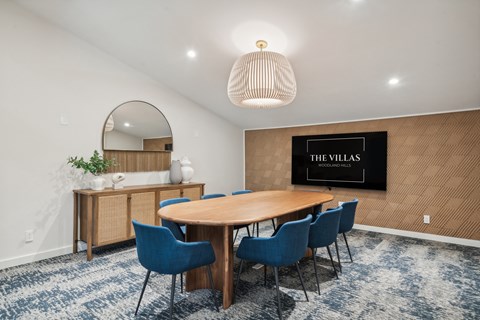 a dining room with a wooden table and blue chairs