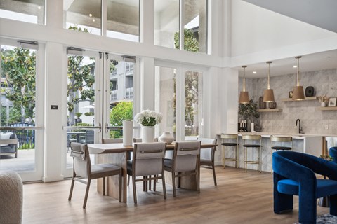 a dining room and living room with a table and chairs