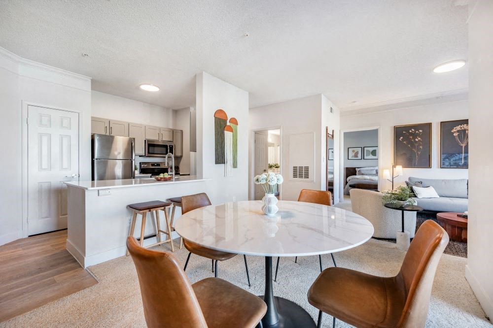 A modern dining room with a round table and chairs.
