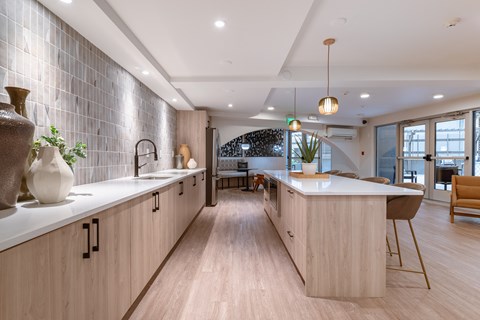 A modern kitchen with wooden cabinets and a white countertop.