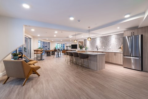 A modern kitchen with a dining area and a living room.
