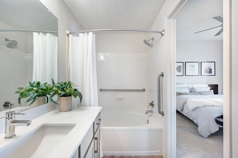 A white bathroom with a white tub and sink.