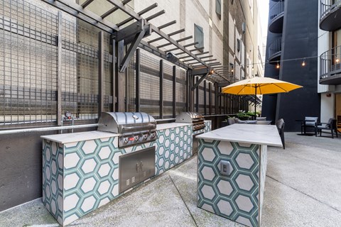 A yellow umbrella is on a table outside.