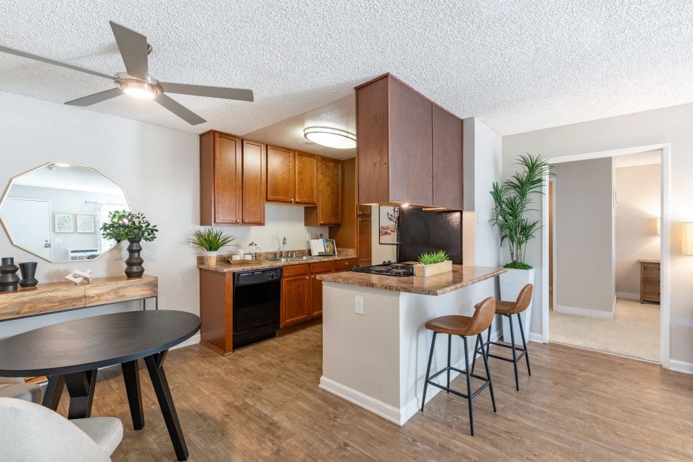 A kitchen with a table and chairs.