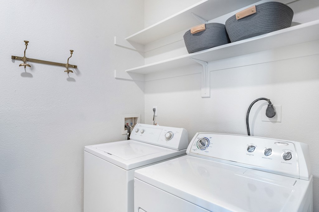 A white laundry room with a washer and dryer. at The Viridian Apartments, Greenwood Village