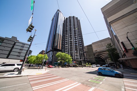 A blue car is parked on the side of the road.