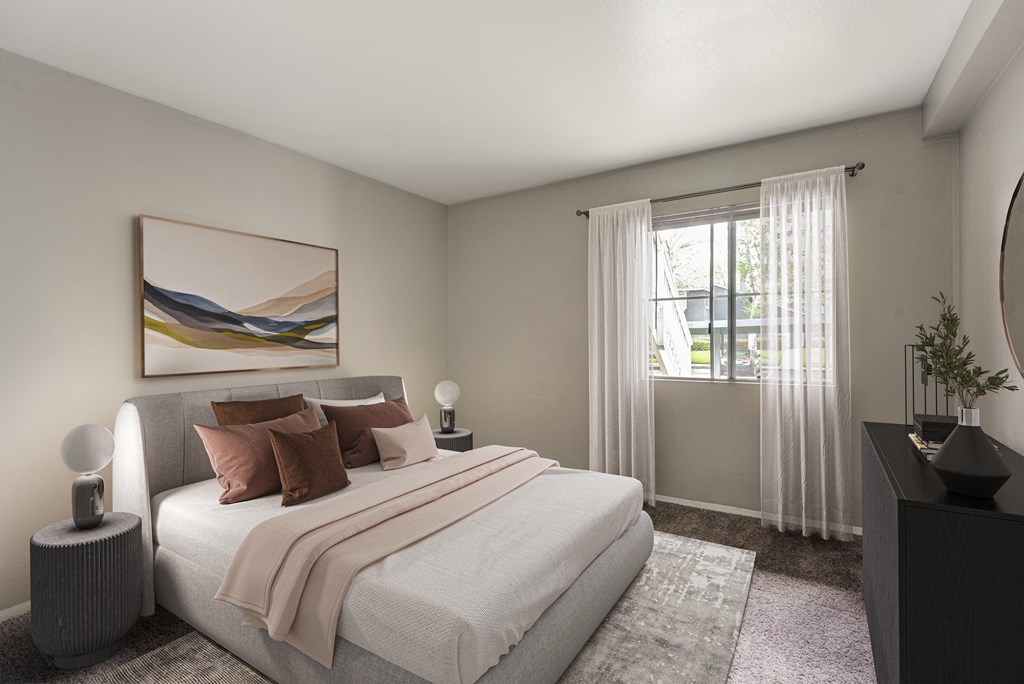 an empty bedroom with a bed and a window