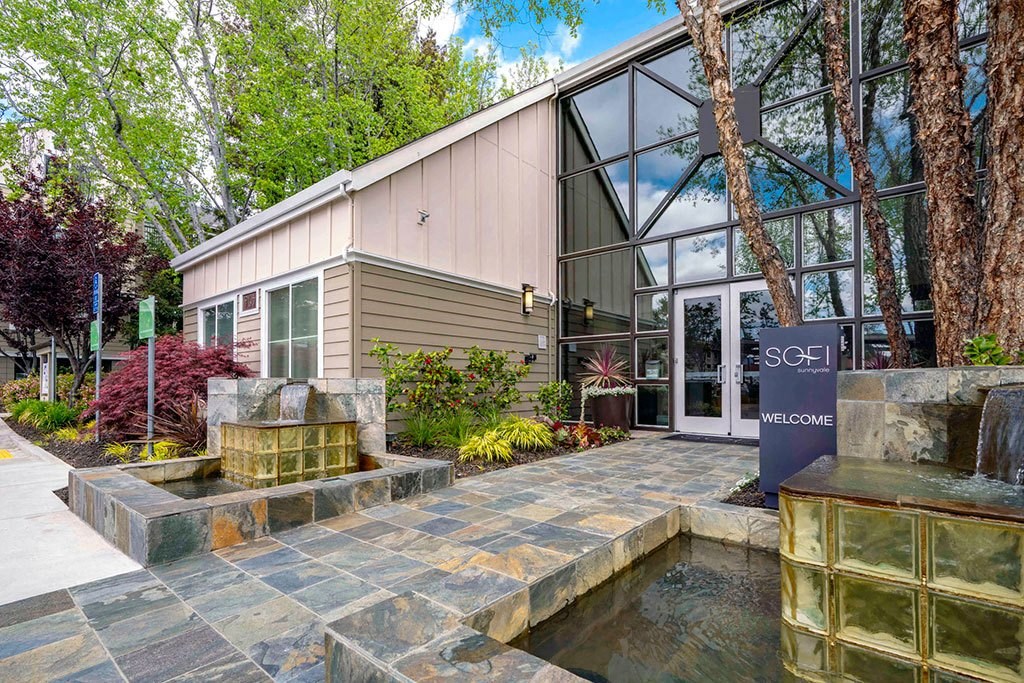 a building with a fountain and a sign in front of it