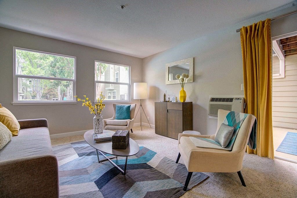 a living room with a couch and chairs