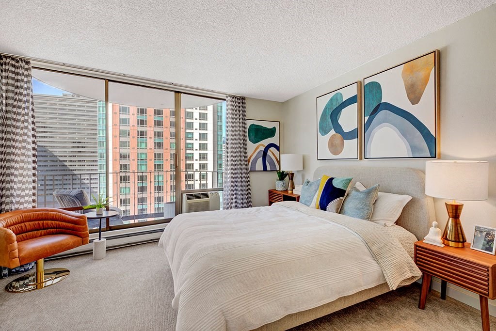 a bedroom with a large bed and a large window