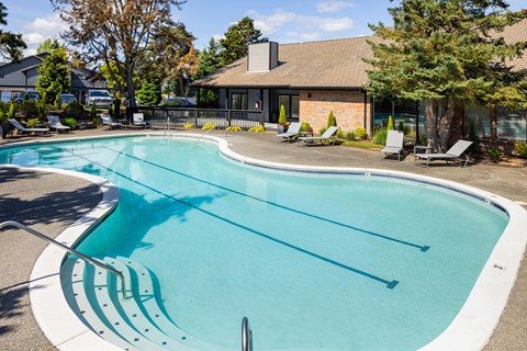 A large outdoor swimming pool with lane markers.