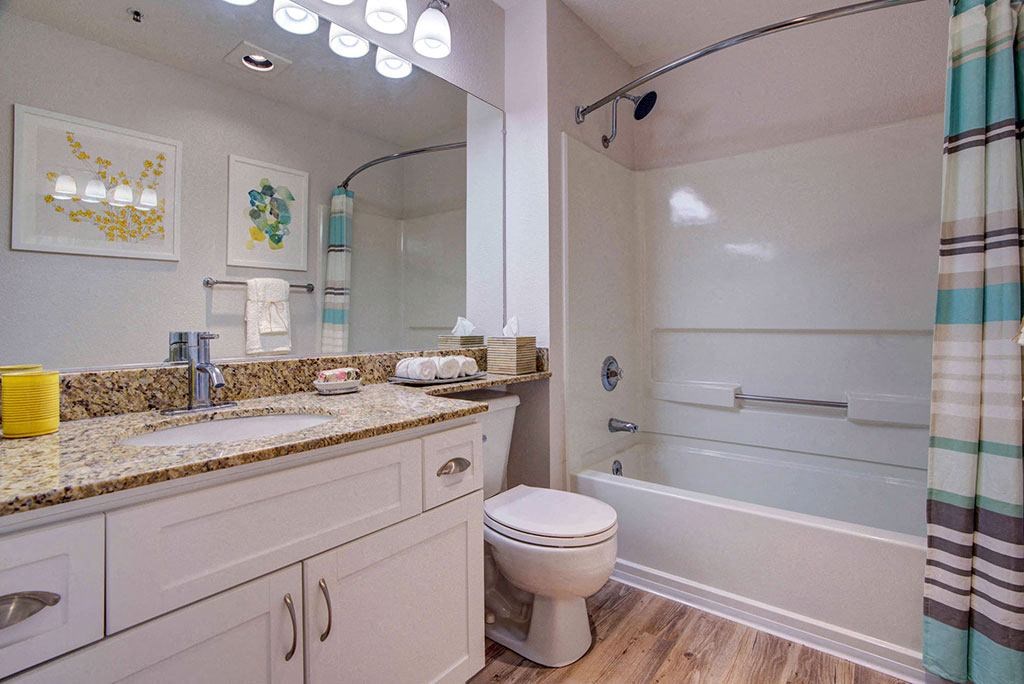 a bathroom with a sink toilet and a bath tub
