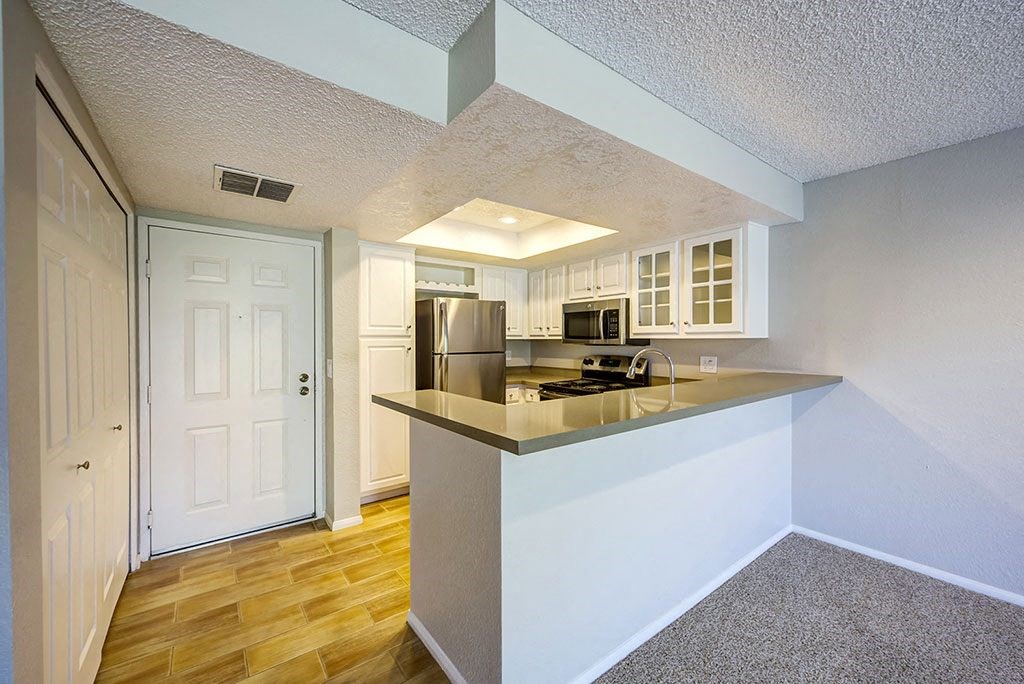 a kitchen with a counter top and a refrigerator
