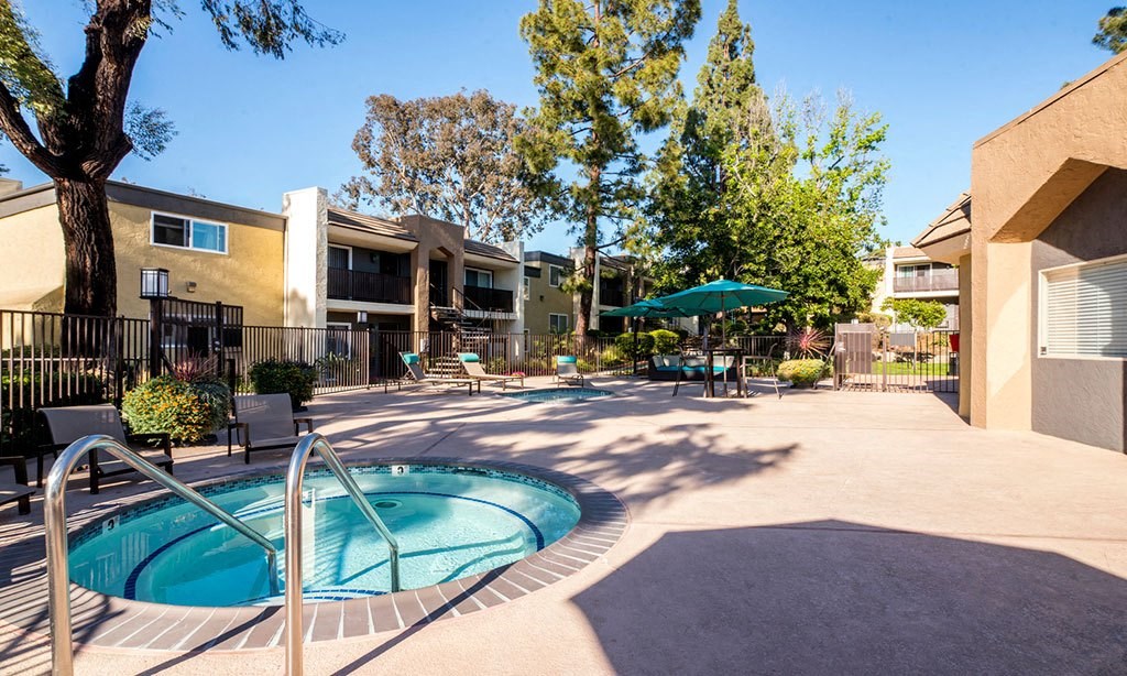 our apartments have a hot tub and a patio with umbrellas