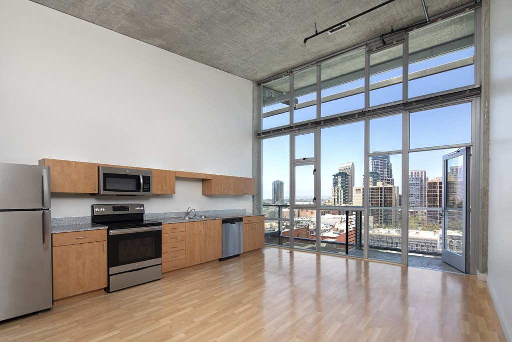 A modern kitchen with wooden cabinets and stainless steel appliances.