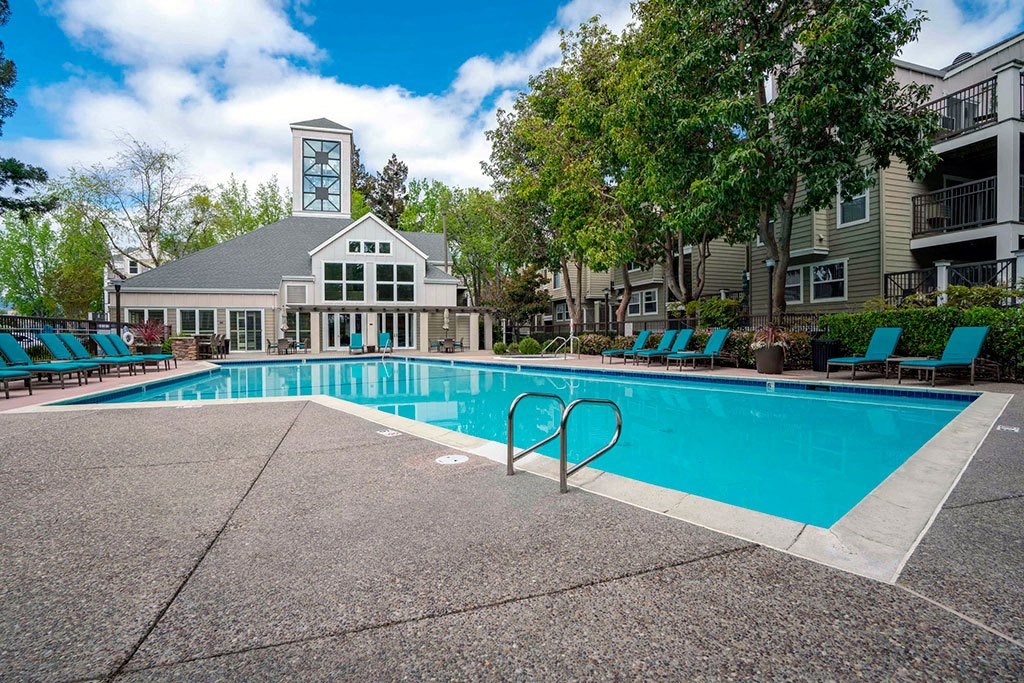 a swimming pool with a building in the background