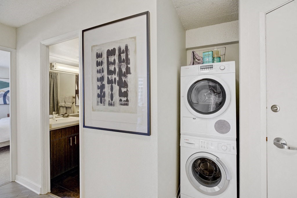 a washer and dryer in a living room next to a door to a