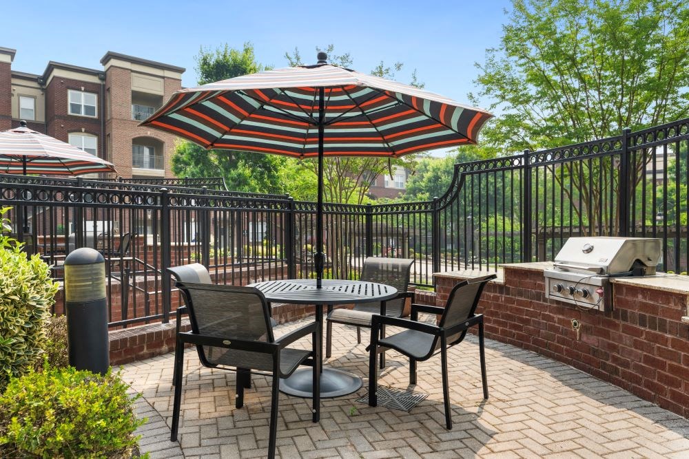 a patio with a table and chairs and an umbrella