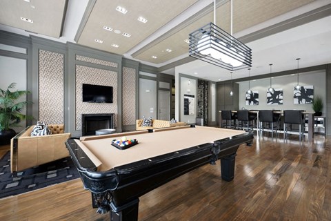 a game room with a pool table and a television