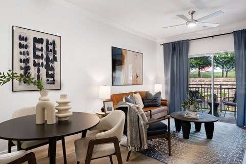 a living room with a couch and a table   and a balcony