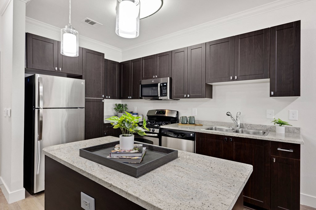 a kitchen with stainless steel appliances and granite counter tops