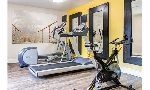 the residence apartments fitness room with exercise equipment