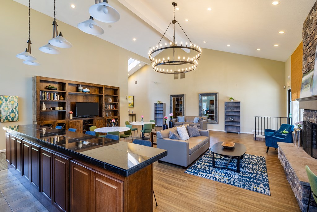 A large open living room with a bar area and a fireplace.
