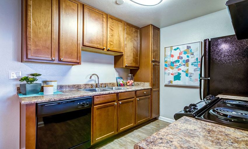 a kitchen with stainless steel appliances and wooden cabinets