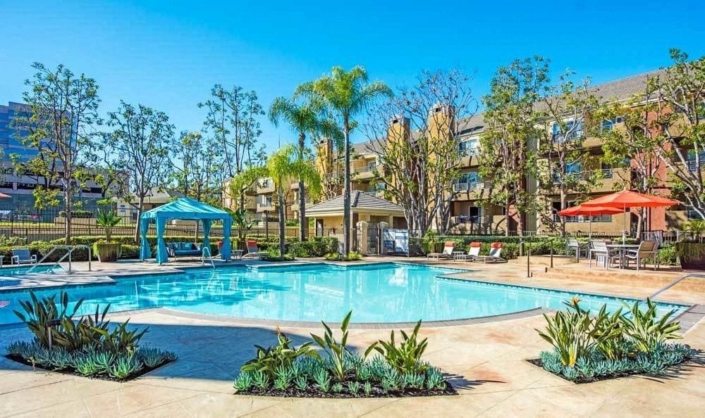 a large swimming pool with a building in the background