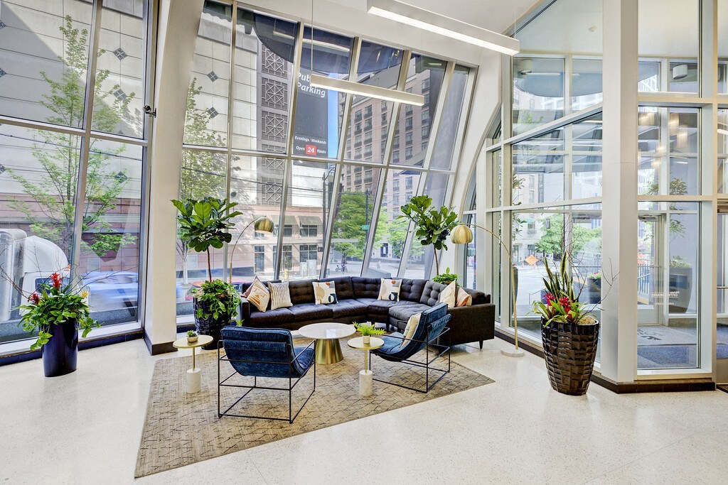 a lobby with couches and chairs and large windows