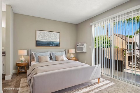 A bedroom with a large bed and a painting on the wall.