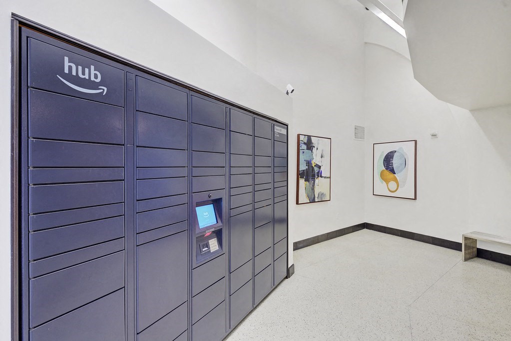 the lockers in a hallway of a building with paintings on the wall