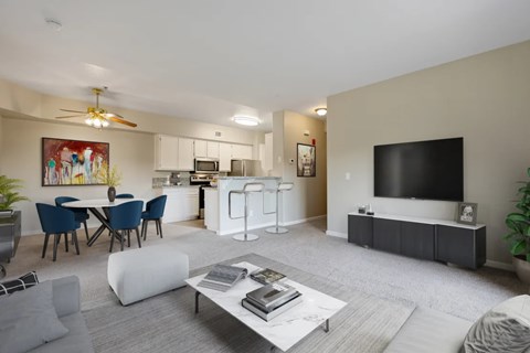 A modern living room with a grey carpet and a white sofa.