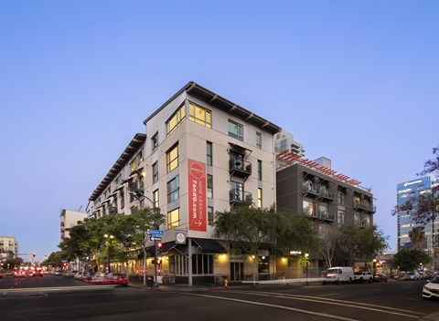 A modern building with a red sign on the front.