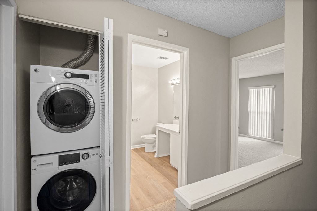 a front loading washer and dryer in a closet in a home