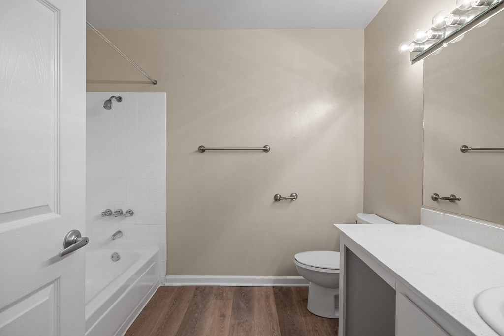 a bathroom with a toilet and a shower and a sink