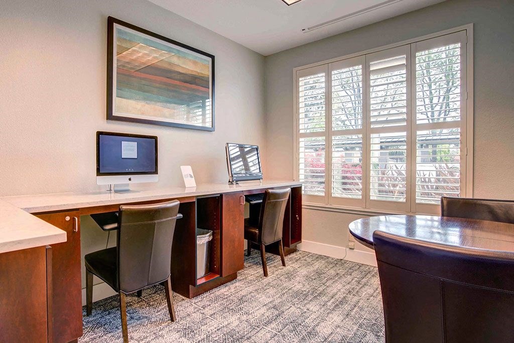 a business center with a desk and a computer