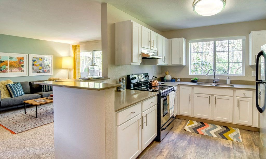 a kitchen with white cabinets and a counter top