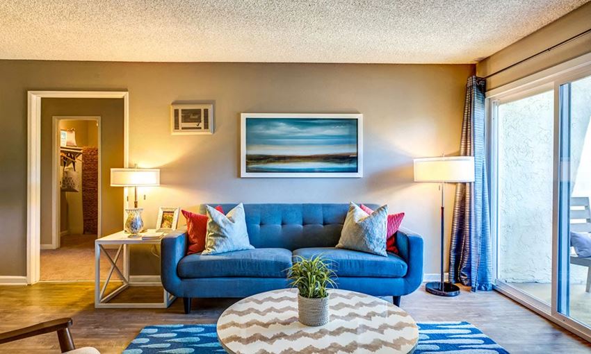 a living room with a blue couch and a table