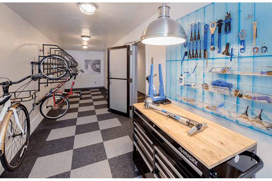 a room with a counter and a bike on the wall