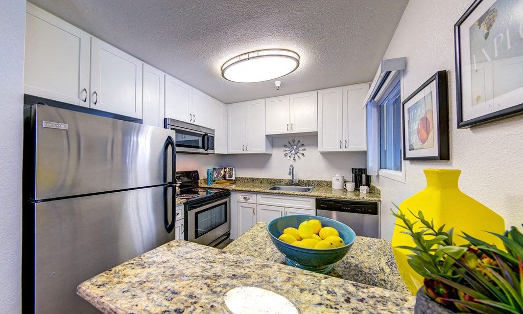 a kitchen with stainless steel appliances and granite counter tops