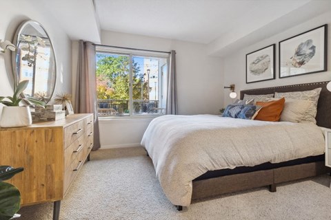 a bedroom with a bed and a window