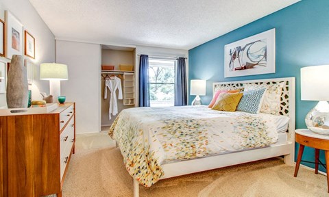 a bedroom with a bed and a dresser and a window