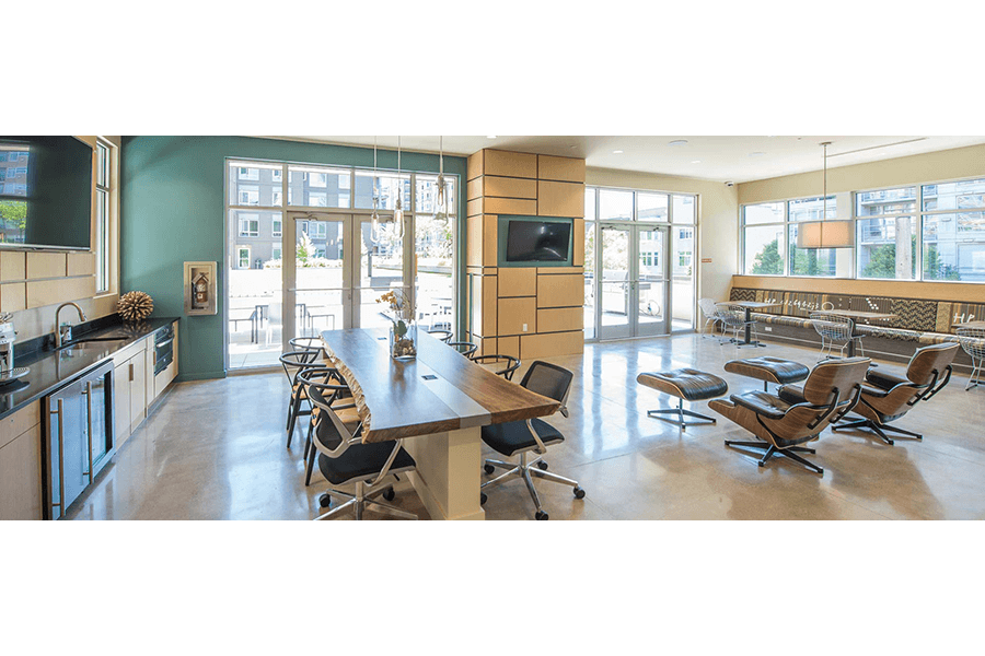 a conference room with a table and chairs and a tv