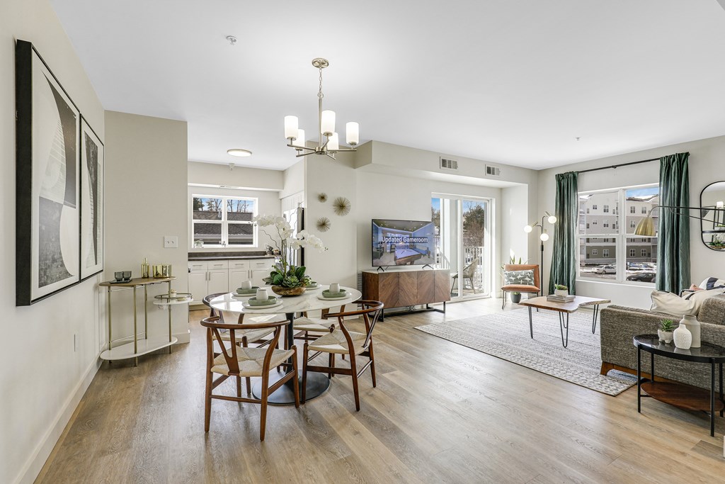 a living room and dining room with a table and chairs