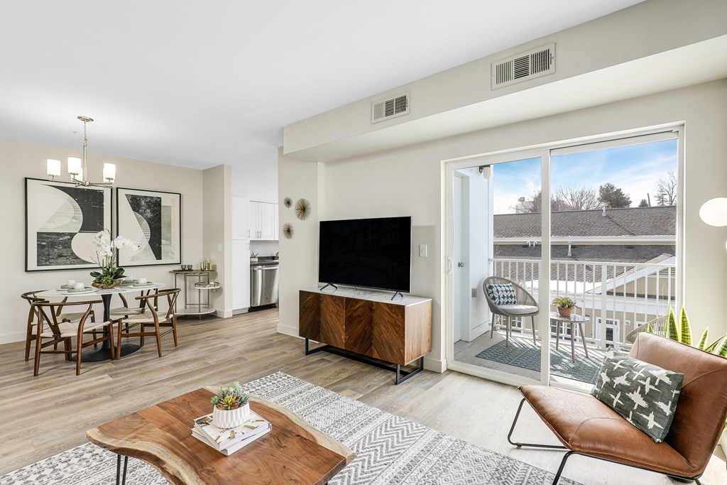 a living room with a tv and a sliding glass door