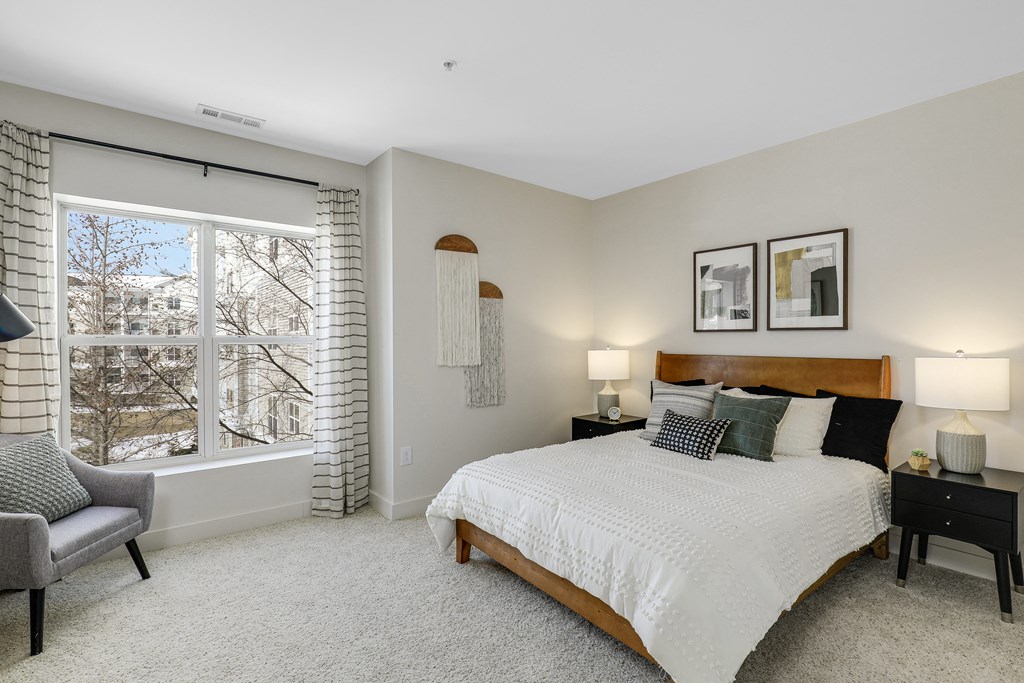 a bedroom with a large bed and a window