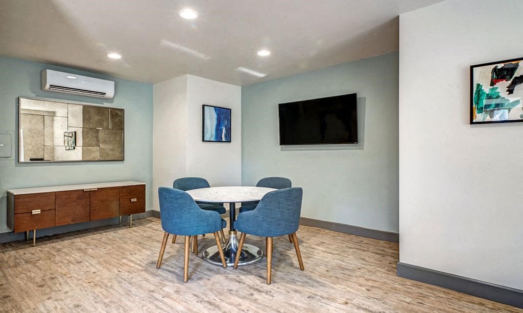 a dining room with a table and chairs and a television